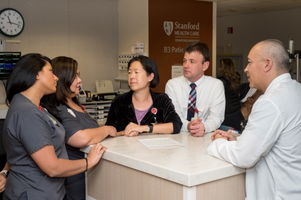 Lisa Shieh (center) speaks with group of physicians and nurses, 2021
